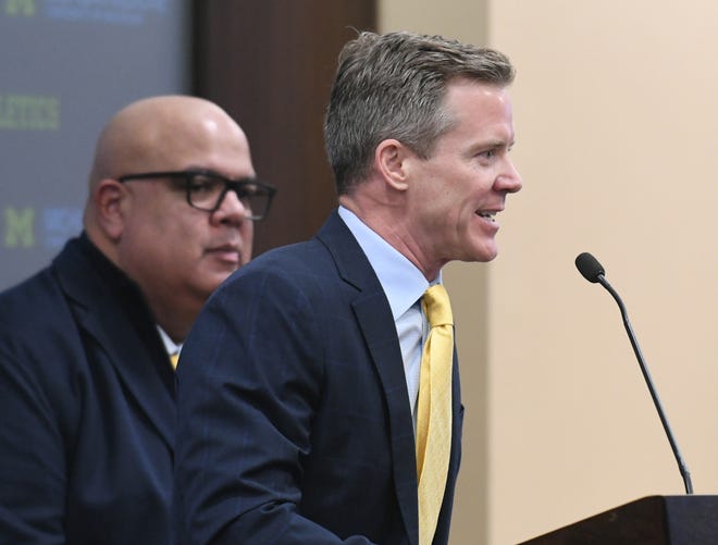 Dusty May is introduced as the new head basketball coach and speaks next to Athletic Director Warde Manuel, left, at the University of Michigan in Ann Arbor, Mich. on Mar. 26, 2024.