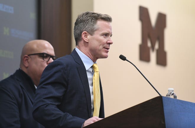 Dusty May is introduced as the new head basketball coach and speaks next to Athletic Director Warde Manuel, left, at the University of Michigan in Ann Arbor, Mich. on Mar. 26, 2024.