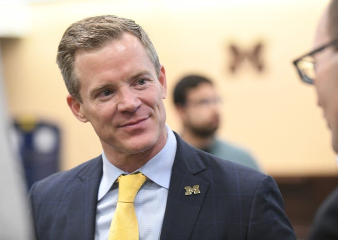 Dusty May talks with people after the press conference where he was introduced as the new head basketball coach at the University of Michigan in Ann Arbor, Mich. on Mar. 26, 2024.