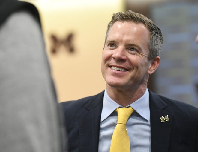 Dusty May talks with people after the press conference where he was introduced as the new head basketball coach at the University of Michigan in Ann Arbor, Mich. on Mar. 26, 2024.