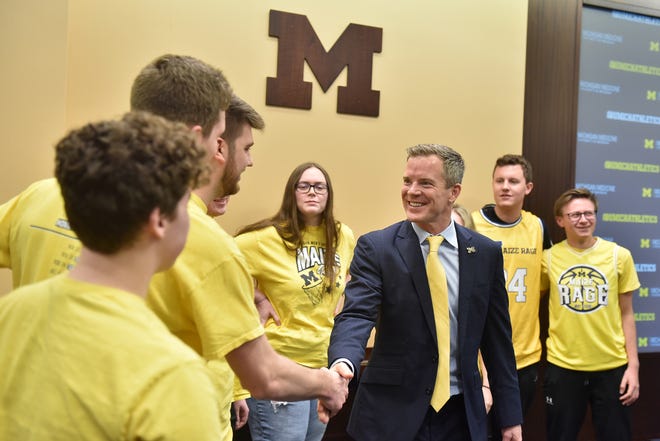 Michigan head basketball coach Dusty May meets members of the Maize Rage after the press conference at the University of Michigan in Ann Arbor, Mich. on Mar. 26, 2024.
