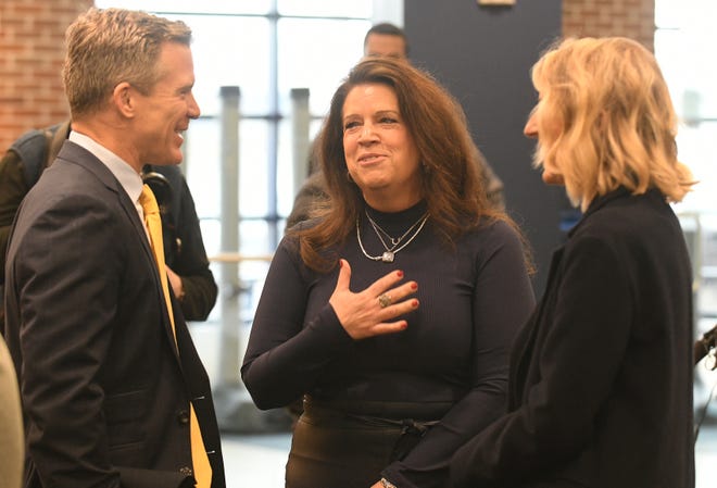 New Michigan head basketball coach Dusty May, left, and his wife, Anna, right, talk with Michigan Board of Regents chair Sarah Hubbard after the press conference at the University of Michigan in Ann Arbor, Mich. on Mar. 26, 2024.