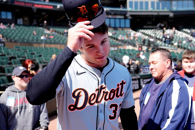 Tigers' Colt Keith heads to the clubhouse after visiting with his father Troy, right, and others before his MLB debut at the White Sox's home opener.