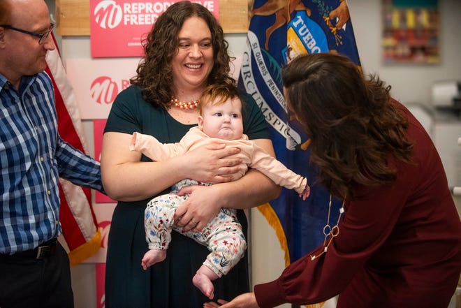 Governor Gretchen Whitmer greets Laura Dennison, center, and her baby, who was conceived through IVF, after taking part in a roundtable discussion on reproductive freedom on Thursday, March 28, 2024 at the Hawk Community Center in Farmington Hills.