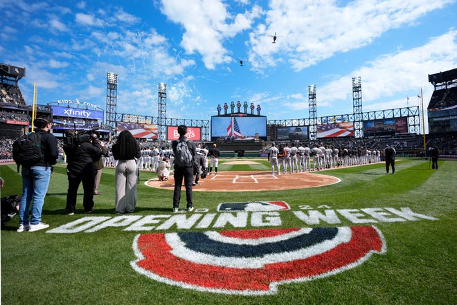 Two U.S. Army helicopters fly over Guaranteed Rate Field during the White Sox's home opener.