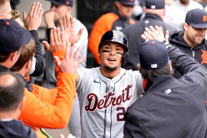 Tigers' Javier Baez celebrates in the dugout after scoring on Andy Ibanez's sacrifice fly off White Sox's Garrett Crochet during the third inning.