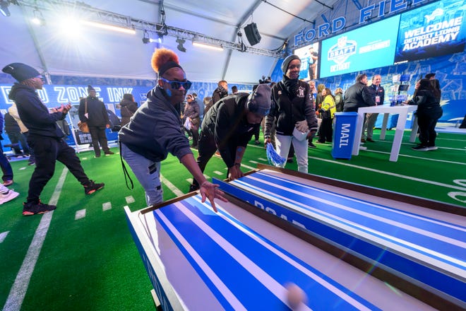 Students from the Detroit Lions Academy get a sneak peek at the activities inside the Detroit Lions Fan Experience Activation at the NFL Draft experience, at Hart Plaza, in Detroit, April 24, 2024.