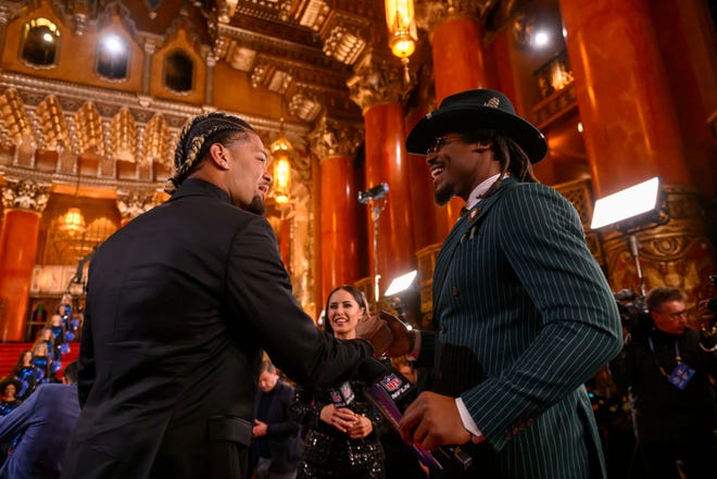 Washington wide receiver Rome Odunze, left, is interviewed by Cam Newton during the NFL Draft red carpet arrival, at the Fox Theatre, in Detroit, April 25, 2024.