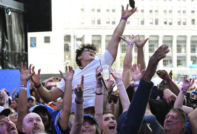 Austin Stadalmiaas of Clinton township leaps up and brings down a t-shirt thrown out to the crowd on day 3 of the NFL Draft 2024 in Detroit, Michigan on April 27, 2024.
