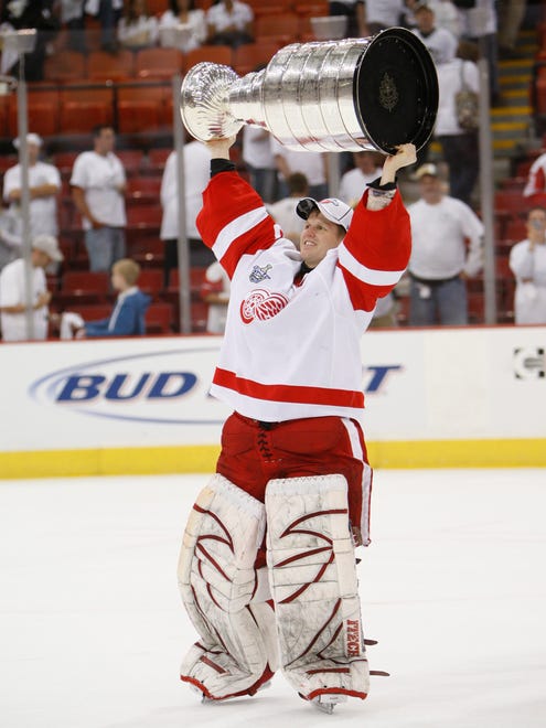 Red Wings goalie Chris Osgood celebrates with the Stanley Cup after Detroit defeated the Pittsburgh Penguins in the Stanley Cup Finals at Mellon Arena in Pittsburgh, Pennsylvania, on June 4, 2008.
