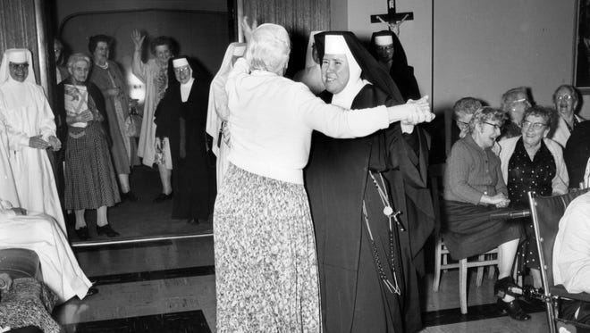 A nun and her partner take to the floor at the Carmel Apartments in Detroit,  July 1962.