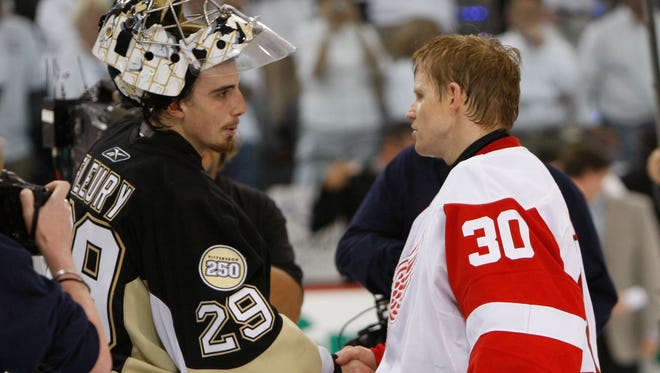 Pittsburgh's Marc-Andre Fleury shakes hands with Detroit's Chris Osgood after the Red Wings defeated the Penguins during Game 6 of the Stanley Cup Finals at Mellon Arena, June 4, 2008.
