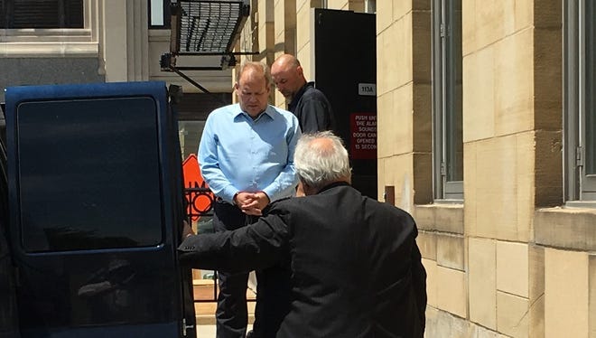 Former Clinton Township trustee Dean Reynolds is led to a van outside federal court in Port Huron after being convicted of bribery and bribery conspiracy charges on Thursday, June 21, 2018.