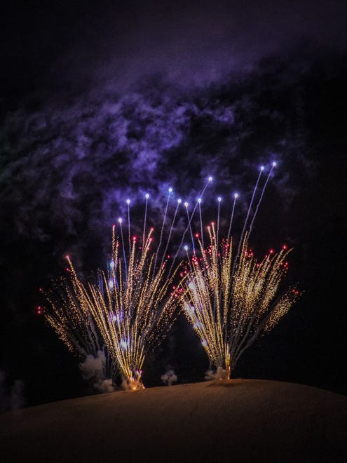"Fireworks at the Dunes," by Eduardo Rojas of Troy.  He was watching the July 4th fireworks  across Silver Lake near Hart, Michigan.  "I noticed it not only lit up the sky but the dunes, too," he said. His photo makes it look like the fireworks are sprouting from the sand dunes.