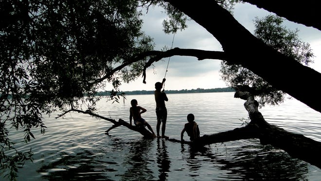Second place: "Boys of Summer," by Cari Taylor of Fremont. "My two boys had their cousin over to play for the day and we decided to go down to swim at Fremont Lake," she said. "It was a beautiful day, but as we were leaving it started to cloud up and sprinkle a little. The cloud cover made the lighting just perfect for this silhouette,  shot on their favorite tree!"