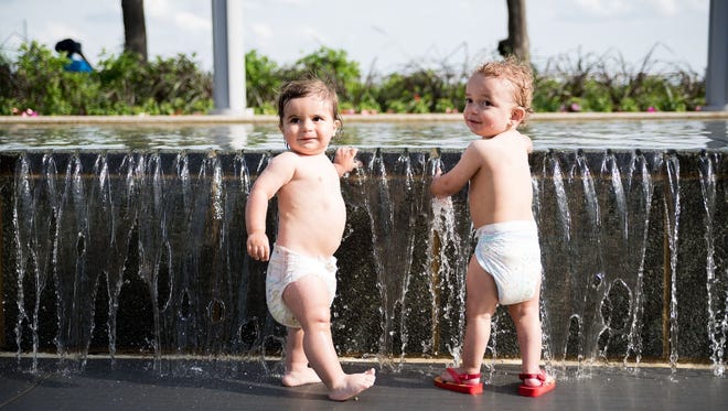 "Give a kid an inch and he'll show you how to enjoy life," wrote Steven Korn of Southfield, who caught these two impish cousins, Monte and Tine, playing in the water by Hart Plaza in Detroit. He calls it  "Sun + Water = Fun."