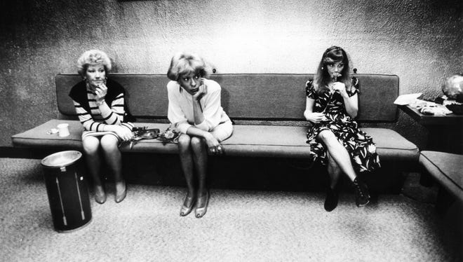 Taxi dancers Donna, Brenda and Taffy wait to be selected for a dance or conversation in April 1985.