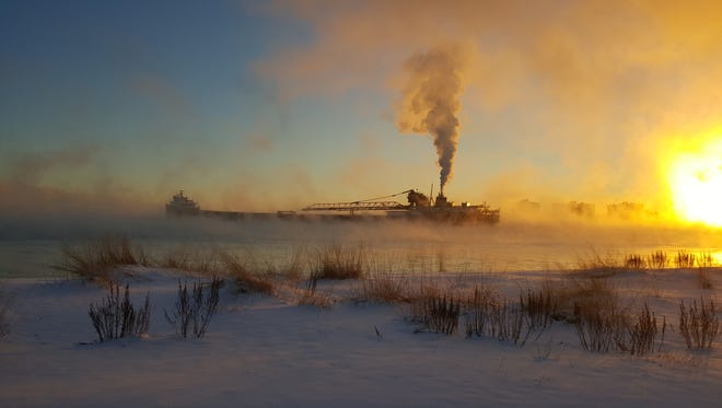 AWARD OF EXCELLENCE: Dennis Delor of Marysville took advantage of the fog, sunrise colors and a ship chugging into Lake Huron to create “Great Lakes Freighter in Winter.”