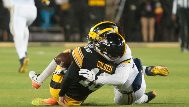 Michigan linebacker Devin Bush received a targeting penalty on this play with Iowa quarterback C.J. Beathard in the first quarter.