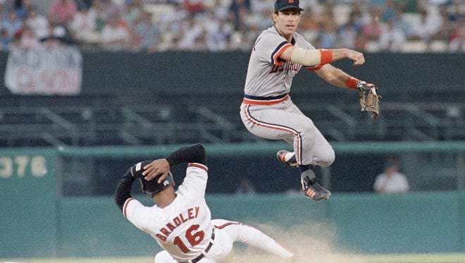 Detroit Tigers' shortstop Alan Trammell turns the double play over the sliding Orioles Phil Bradley in the third inning of their Saturday night, July 1, 1989 game at the Memorial Stadium, Baltimore.