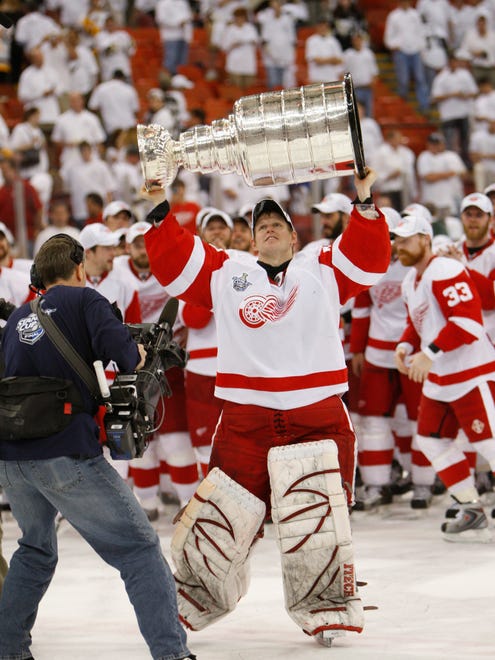 Red Wings goalie Chris Osgood celebrates with the Stanley Cup after Detroit defeated the Pittsburgh Penguins in the Stanley Cup Finals at Mellon Arena in Pittsburgh, Pennsylvania, on June 4, 2008.