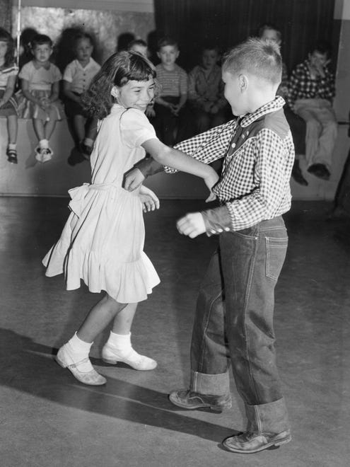 Children do-si-do at a folk dance in 1954.