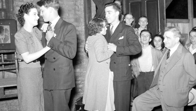 A chaperone keeps an eye on the dancing couples at Cass Community M. E. Church in Detroit, June 1938.