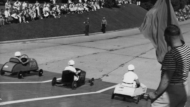 These contestants in 1937 get a start on a ramp. The soap box cars were fueled entirely by gravity. Car and driver had to weigh in at 250 pounds or less.