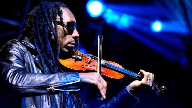 Violinist Boyd Tinsley plays on the song #41.  The seven-piece Dave Matthews Band performed an hour-long acoustic set followed by a two-hour electric set in front of a capacity crowd at DTE Music Theater in Clarkston, Michigan during its 2015 summer tour.