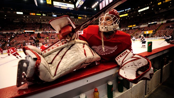 Goalie Chris Osgood stretches by the Red Wings bench in 2008.