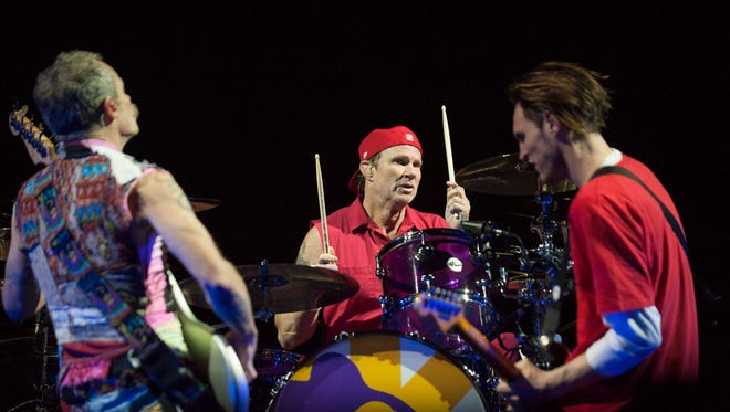 Red Hot Chili Peppers Bassist Flea (Michael Peter Balzary), drummer Chad Smith (Bloomfield Hills) and guitarist Josh Klinghoffer play an instrumental jam to kick off the show at Joe Louis Arena in Detroit.