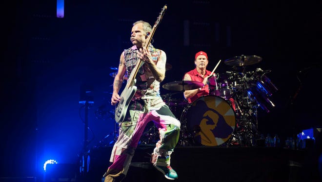 Red Hot Chili Peppers Bassist Flea (Michael Peter Balzary) and drummer Chad Smith (Bloomfield Hills) perform at Joe Louis Arena in Detroit during their Getaway World Tour.