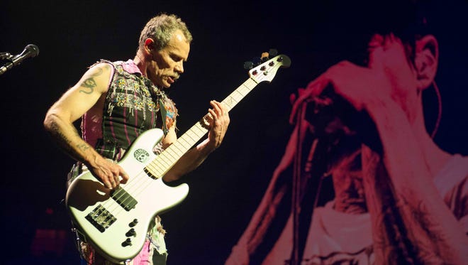 Red Hot Chili Peppers Bassist Flea (Michael Peter Balzary) performs on stage at Joe Louis Arena in Detroit during the band's Getaway World Tour.