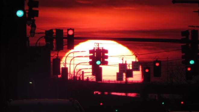 "Lafayette Sunset #2," by Russell Dunn of Royal Oak, makes a polka dot pattern out of the traffic lights on Lafayette Boulevard in Detroit, accented by the dramatic red sky and setting sun.