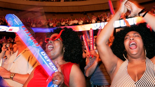 Fans Andrenetta Gibson and Jaymie Woods cheer the Pistons during Game 4 of the NBA Finals against the San Antonio Spurs on June 16, 2005.