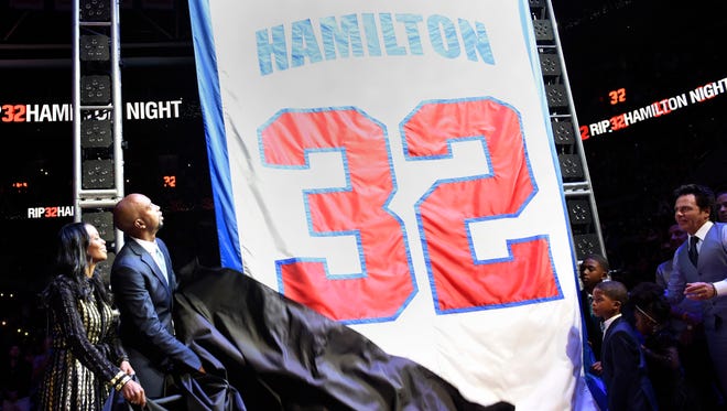Richard Hamilton, his wife T.J. Lottie and their sons and Pistons owner Tom Gores unveil Hamilton's jersey, which was retired in a ceremony on February 26, 2017.