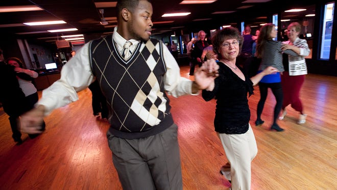 Aswad Ray-EL, left, 23 from Detroit and Betty Joritz of Berkley practice their dance moves during a weekly dance party Thursday April 12, 2012 at the Arthur Murray Studio in Royal Oak.