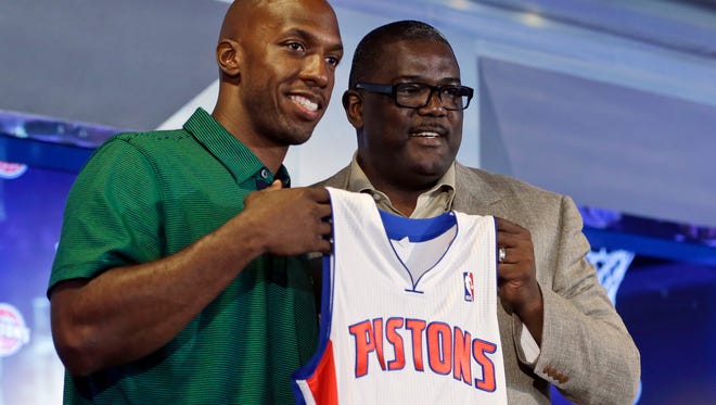 Free agent guard Chauncey Billups, left, and Detroit Pistons President of Basketball Operations Joe Dumars pose with Billups' jersey after Billups' introduction to the media as the newest member of the team on July 16, 2013. Billups, who was a member of the Pistons for six years, returned to the team as a player and a mentor to the younger players.