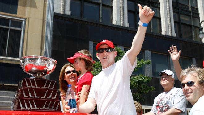 Red Wings goalie Chris Osgood rolls down Woodward Avenue with the Jennings Trophy during the Stanley Cup parade, June 4, 2008.