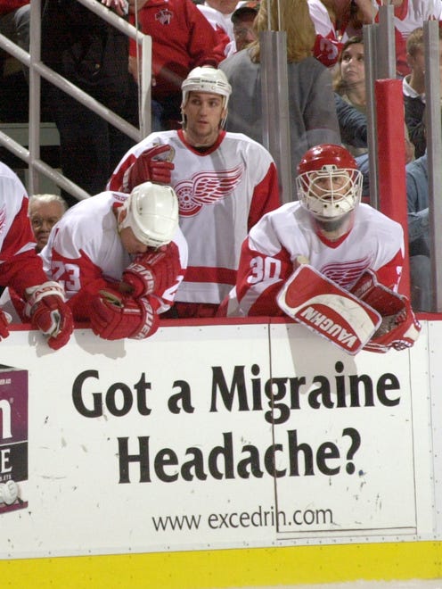 (from left) Todd Gill, Mathieu Dandenault, and Chris Osgood watch the final moments of the Detroit Red Wings' 3-2 loss to the Los Angeles Kings in Game 5 of the first round of the Stanley Cup Playoffs in Detroit, April 21, 2001.
