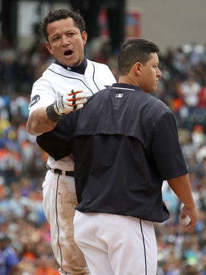 The Tigers' Miguel Cabrera is held back during a sixth-inning bench-clearing fight with the New York Yankees.