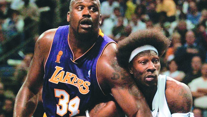 Ben Wallace tries to keep Shaquille O'Neal in check as the Detroit Pistons take on the Los Angeles Lakers in Game 3 of the NBA Finals  on June 10, 2004.