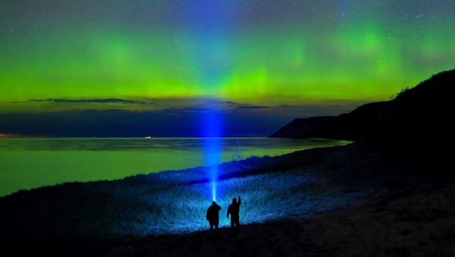 EDITOR'S CHOICE WINNER: In "Aurora Hunters," Dale Niesen of South Rockwood used two LED flashlights, a wide angle lens and a 15-second exposure to create this cool shot himself and his friend Steve Lambert watching the northern lights near Empire Bluffs in the Sleeping Bear Dunes National Lakeshore.