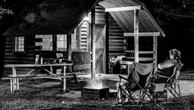 While camping at the KOA in Port Huron, Derek Jackson of Point Edward, Ontario and his 12-year-old son Bailey set the camera "for a 30-second long exposure to gather lots of light.  During the exposure we painted light on the front of the cabin with an LED flashlight to highlight certain areas, while lighting my wife and younger son with the campfire.  Our goal was to capture a photograph that would give people the feeling of being there."