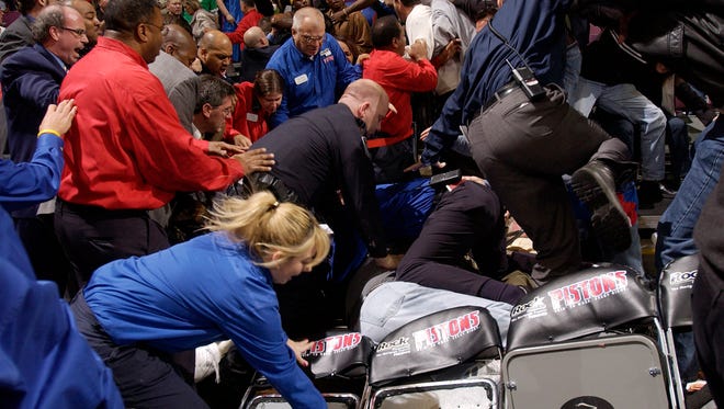 Palace security people rush into the stands to separate Indiana Pacers players and Pistons fans during the infamous "Malice at The Palace" brawl  on November 19, 2004.