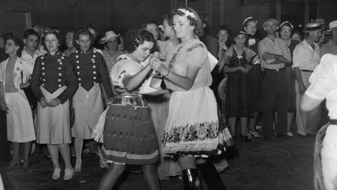 Girls dance, perhaps to the polka, in August 1939.