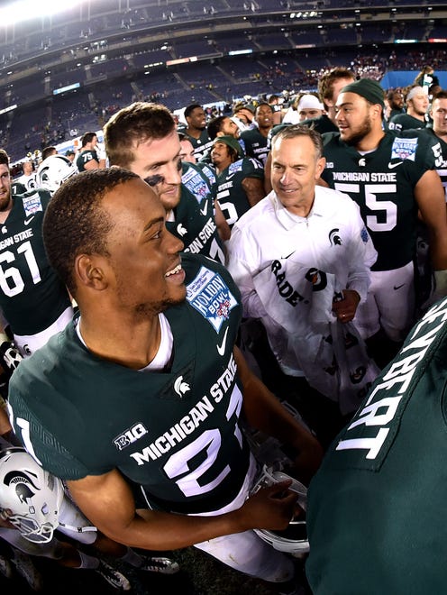 Cam Chambers (21) grins while celebrating with Mark Dantonio after Thursday night's victory.