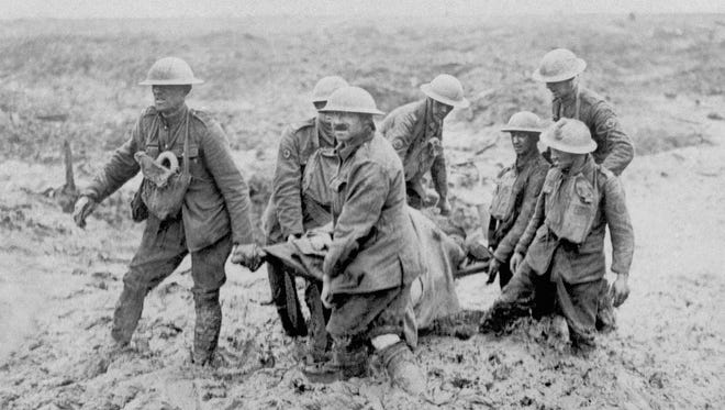 A stretcher bearer patrol makes its way through mud near Bol Singhe during the British advance in Flanders; some of the men were nearly knee deep in the swampy ground, Aug. 20, 1917.