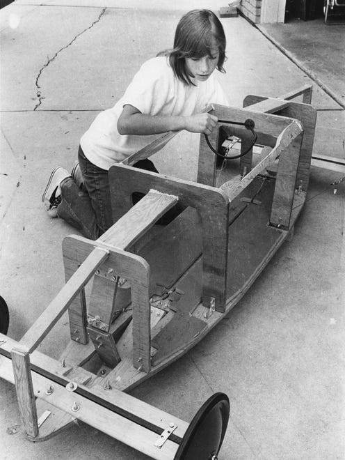 Cindy Winters works on her car in 1971, the first year girls competed in the Soap Box Derby.