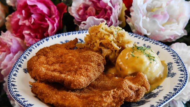 Chicken schnitzel with sauerkraut and mashed potatoes and gravy.  And while the menu is predominately Polish, from pierogis and stuffed cabbage to fresh and smoked kielbasa, there are other options, including burger and fries, and fish and chips, served on blue-and-white patterned plates .